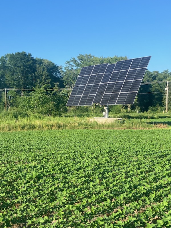 Dual-axis solar tracker at a Powell Electrical installation in a farm field